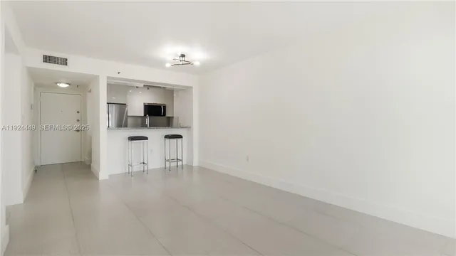 an empty room with kitchen and a sink
