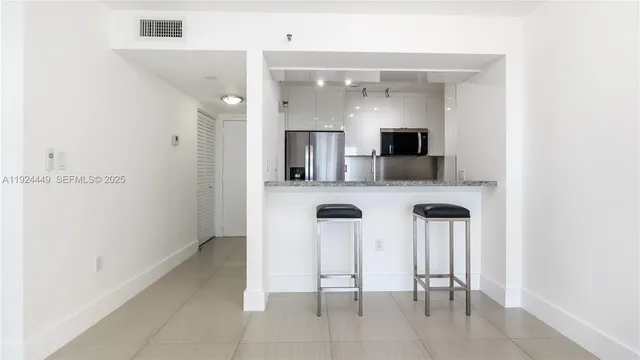 a kitchen with stainless steel appliances kitchen island microwave and cabinets