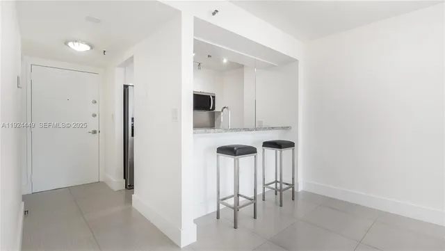 a view of a hallway with chairs and table