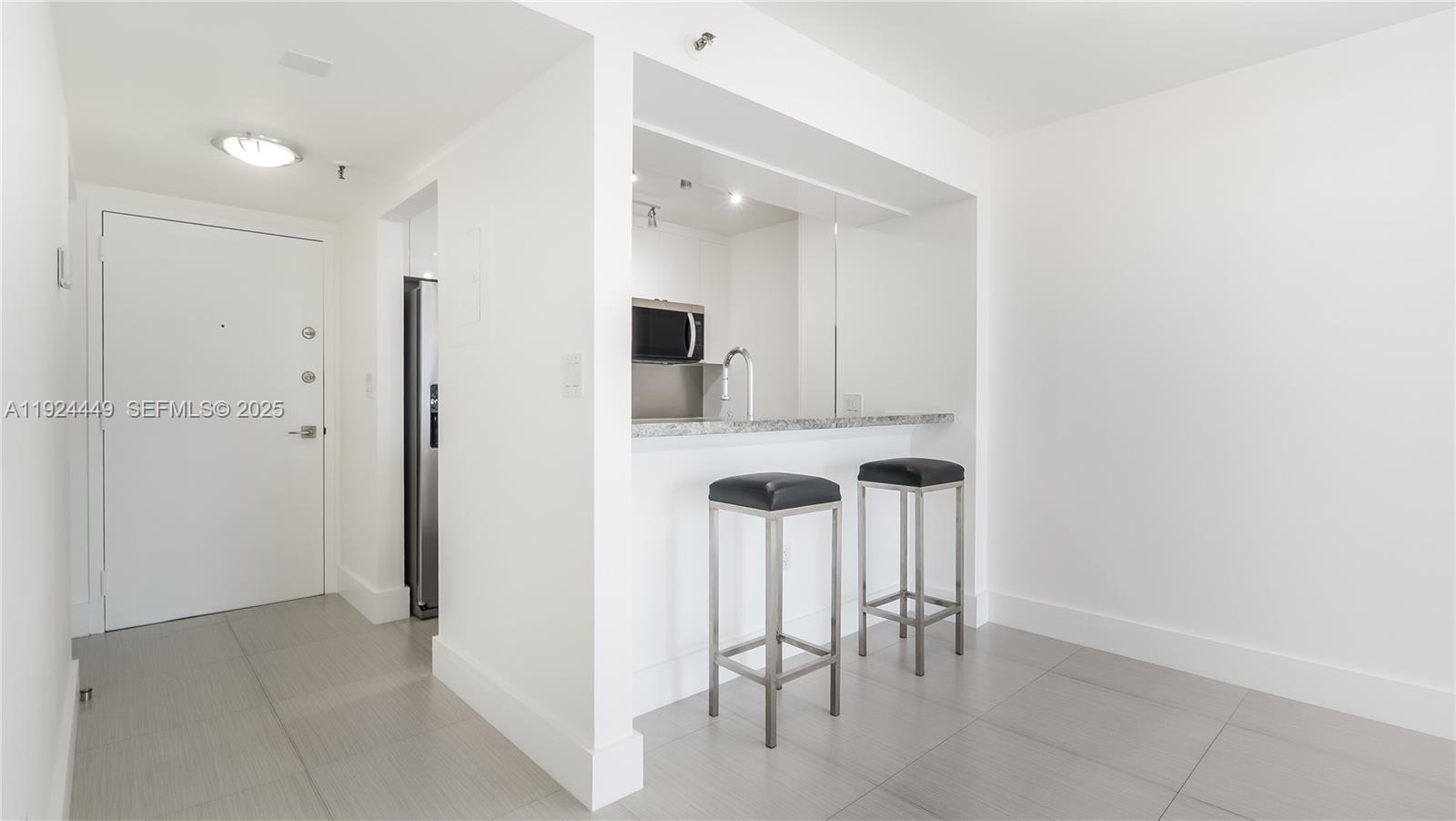 850 North Miami Avenue, Unit W1707 Miami, FL 33136 - Photo 7 of 35 a view of a hallway with chairs and table