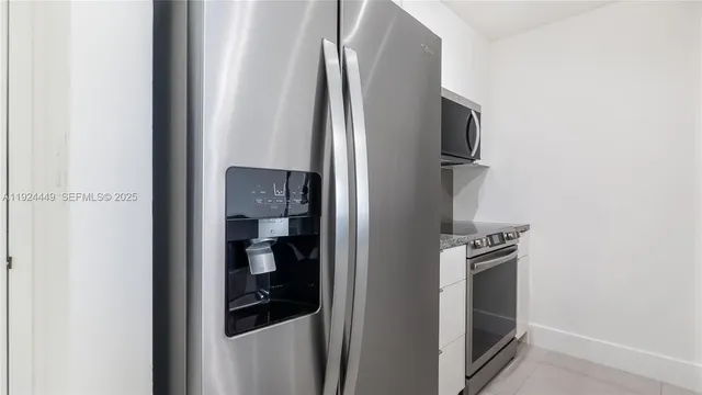 a close view of water heater and a refrigerator in a kitchen