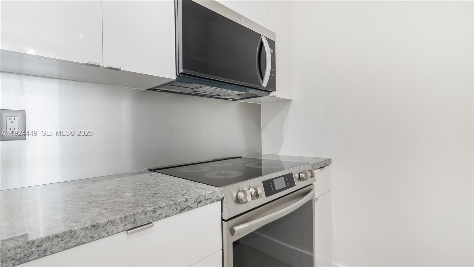 850 North Miami Avenue, Unit W1707 Miami, FL 33136 - Photo 10 of 35 a kitchen with a stove and a microwave