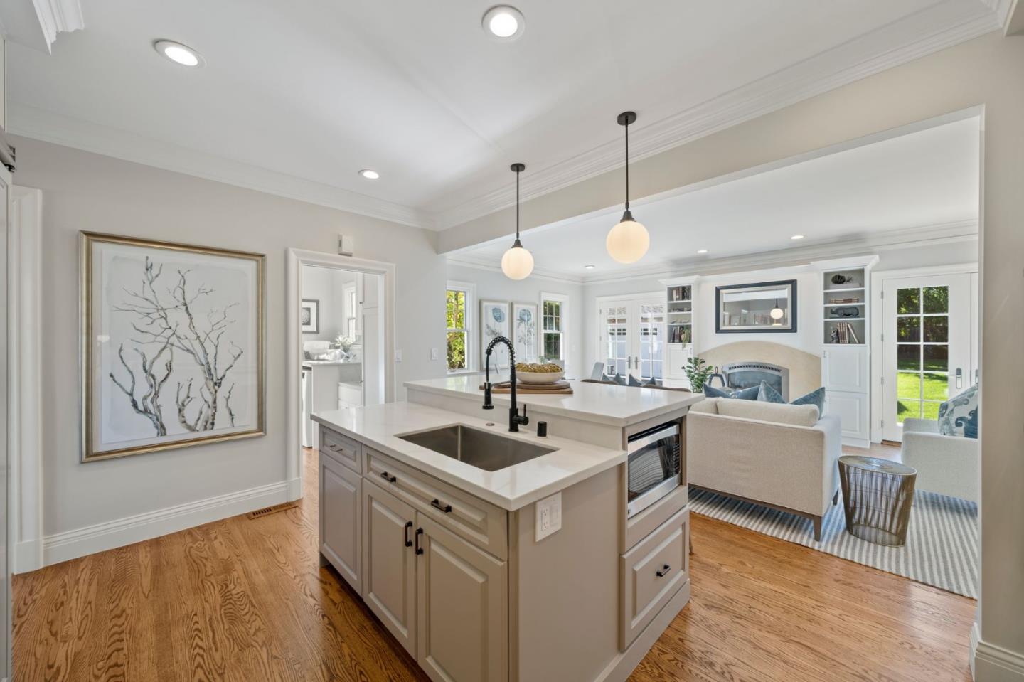 445 Hillcrest Road San Mateo, CA 94402 - Photo 11 of 41 a kitchen that has a lot of cabinets a sink and wooden floor
