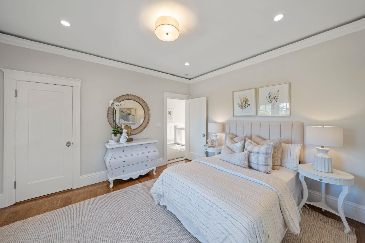445 Hillcrest Road San Mateo, CA 94402 - Photo 23 of 41 a spacious bedroom with a bed and a chandelier