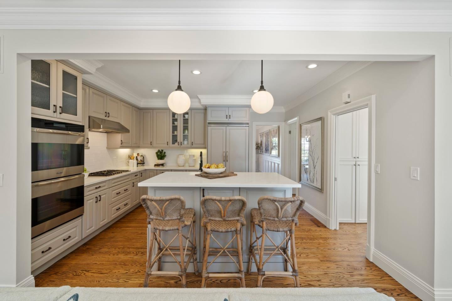 445 Hillcrest Road San Mateo, CA 94402 - Photo 10 of 41 a kitchen with a dining table wooden floor and stainless steel appliances