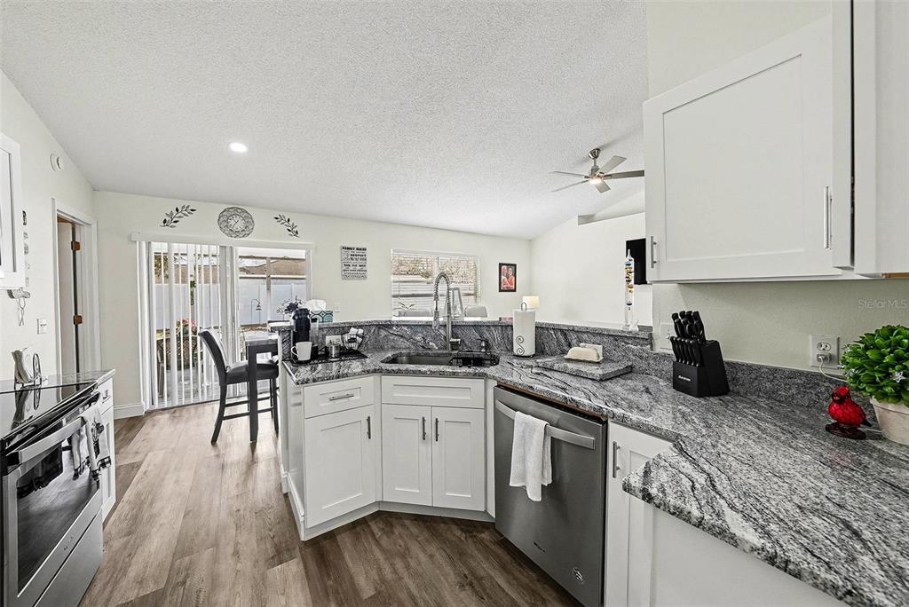 3267 Guava Lane Spring Hill, FL 34609 - Photo 11 of 30 a kitchen with lots of counter top space and wooden floor