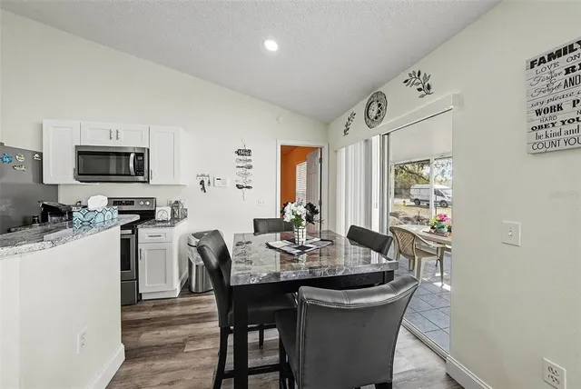 a view of a dining room with furniture and wooden floor