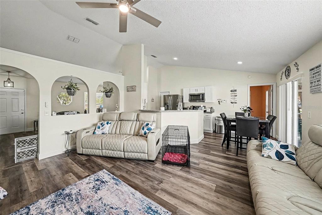 3267 Guava Lane Spring Hill, FL 34609 - Photo 13 of 30 a living room with furniture kitchen view and a wooden floor