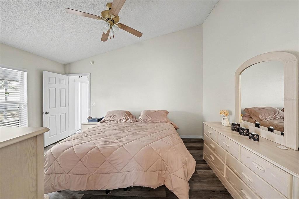 3267 Guava Lane Spring Hill, FL 34609 - Photo 16 of 30 a bedroom with a bed and a chandelier