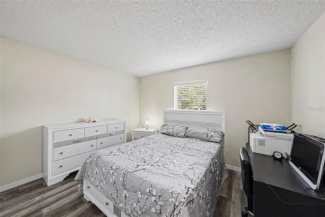 a bedroom with a bed and a desk