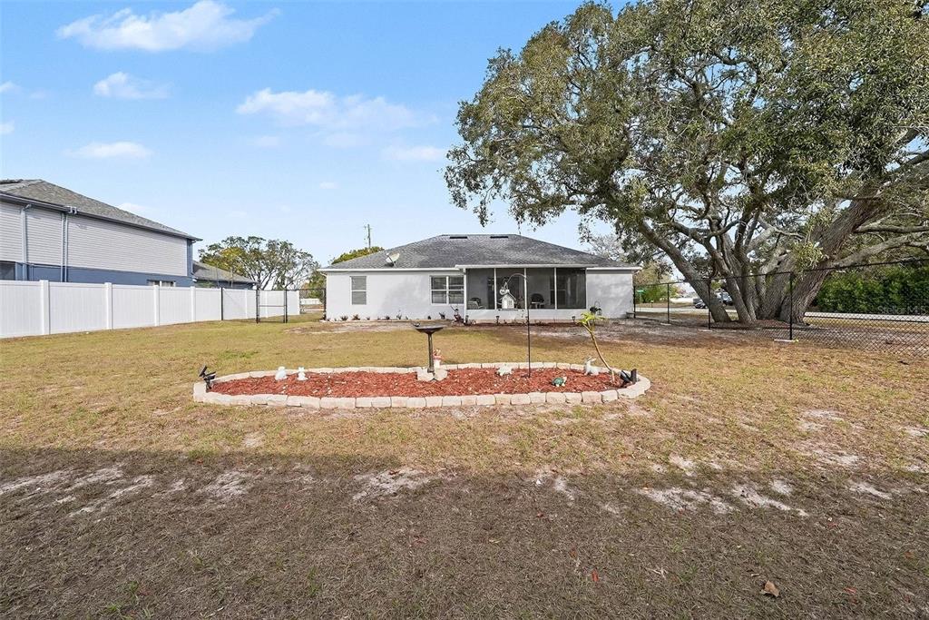 3267 Guava Lane Spring Hill, FL 34609 - Photo 28 of 30 a view of pool with umbrella and trees in the background
