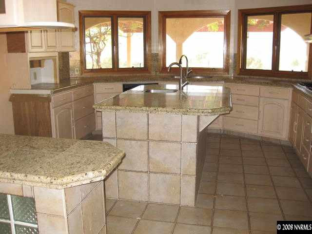 3355 Bacon Rind Road Reno, NV 89510 - Photo 2 of 9 a kitchen with kitchen island granite countertop a sink a counter appliances and cabinets