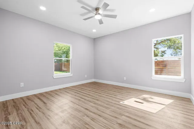 wooden floor in an empty room with a window