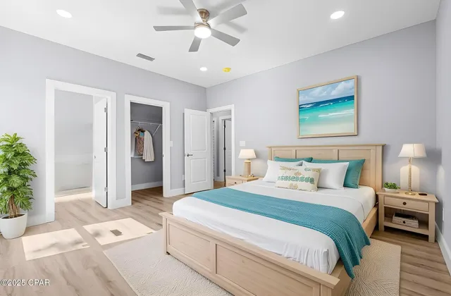 a spacious bedroom with a large bed and a chandelier