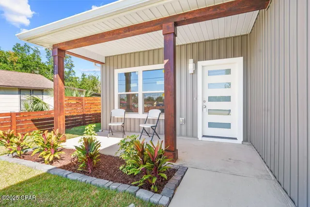 a front view of a house with a garden