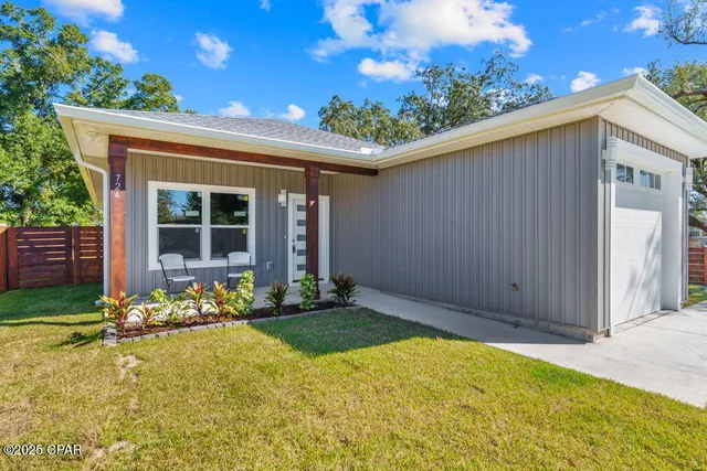 a front view of a house with a garden