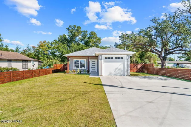 a front view of a house with a garden