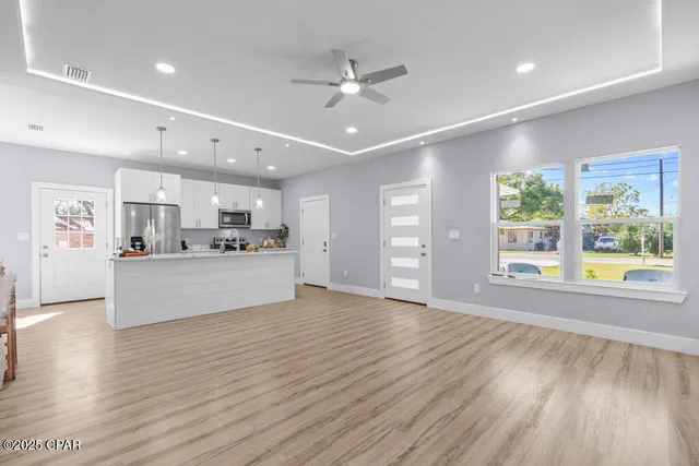 a view of kitchen with cabinets and wooden floor