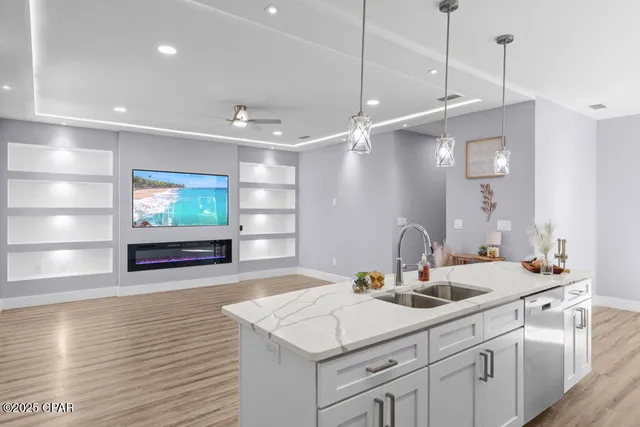 a bathroom with a sink a large mirror and vanity