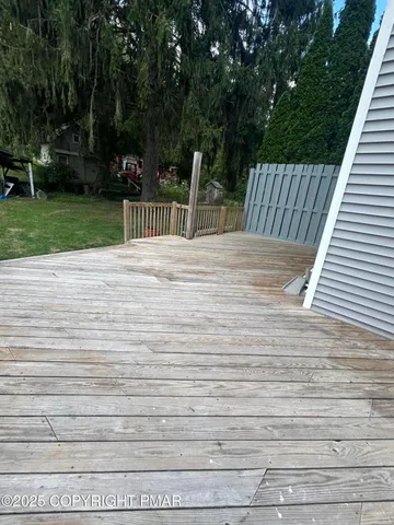 a view of outdoor space with deck and yard