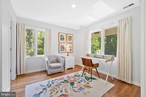 a bedroom with a bed and a lamp next to a window