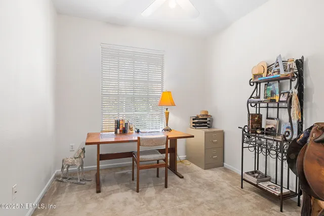 a dining room with furniture and a window