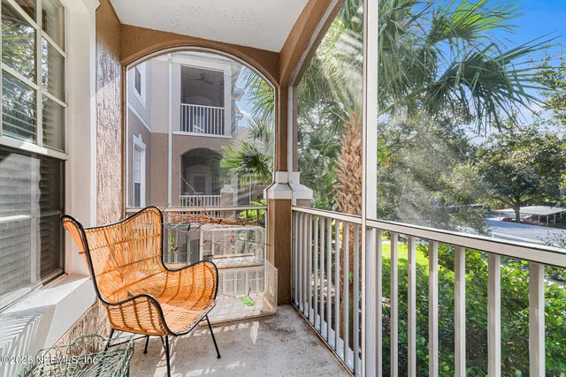 a view of a chair and tables in the balcony