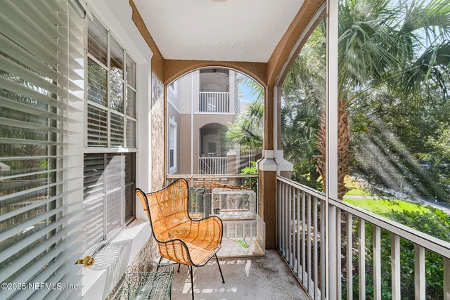 a view of a chair and tables in the balcony