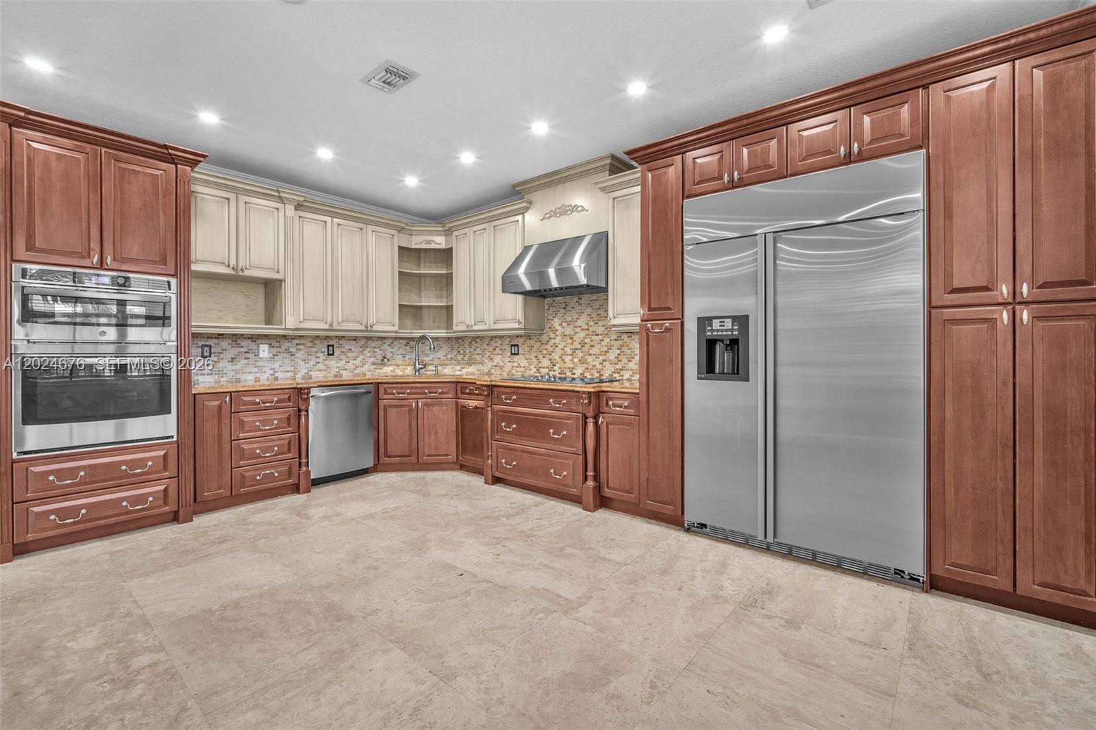 2155 Southwest 156th Court Miami, FL 33185 - Photo 24 of 57 a kitchen with stainless steel appliances granite countertop a refrigerator and a stove top oven