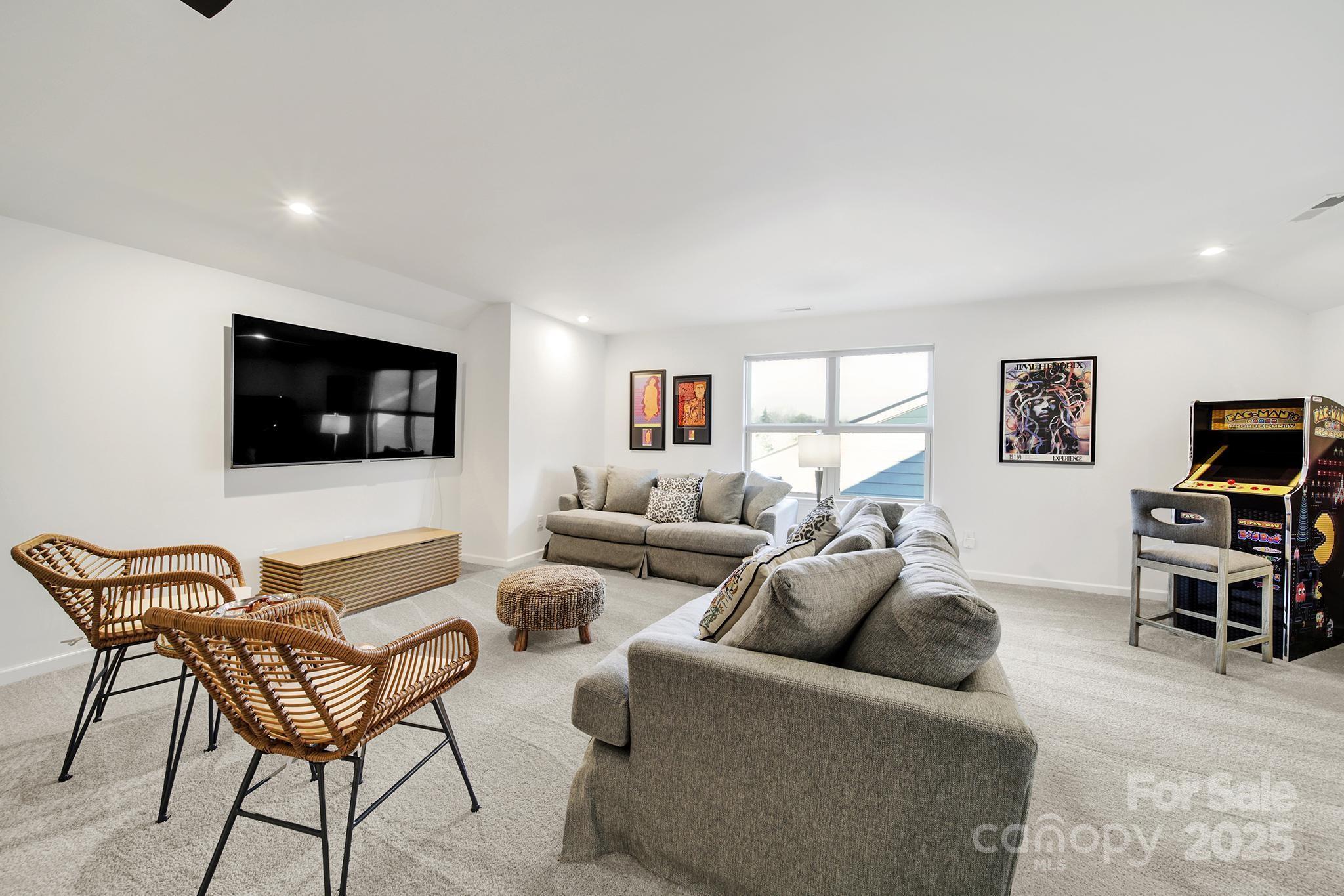 3135 Bartlett Street Fort Mill, SC 29715 - Photo 24 of 43 a living room with furniture and a flat screen tv