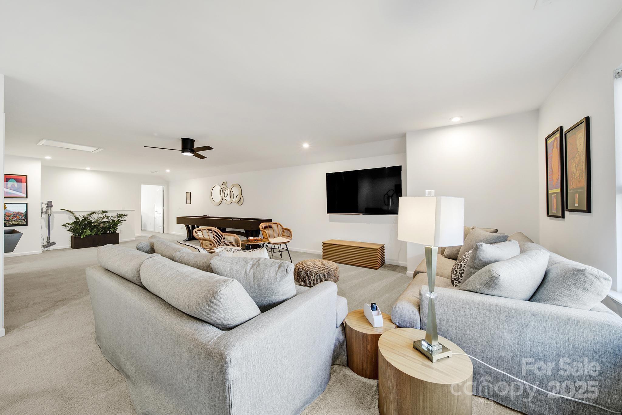 3135 Bartlett Street Fort Mill, SC 29715 - Photo 25 of 43 a living room with furniture and a flat screen tv