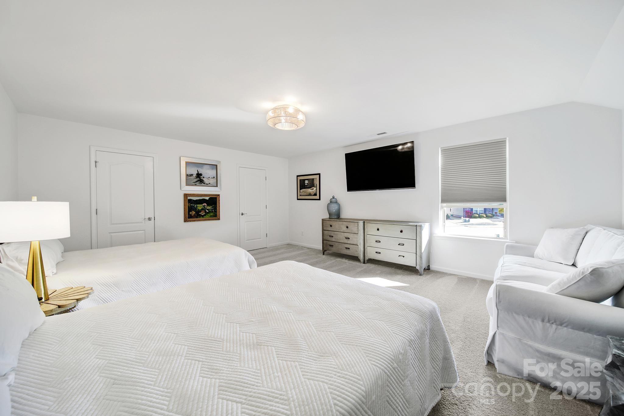 3135 Bartlett Street Fort Mill, SC 29715 - Photo 26 of 43 a bedroom with a bed and a flat screen tv