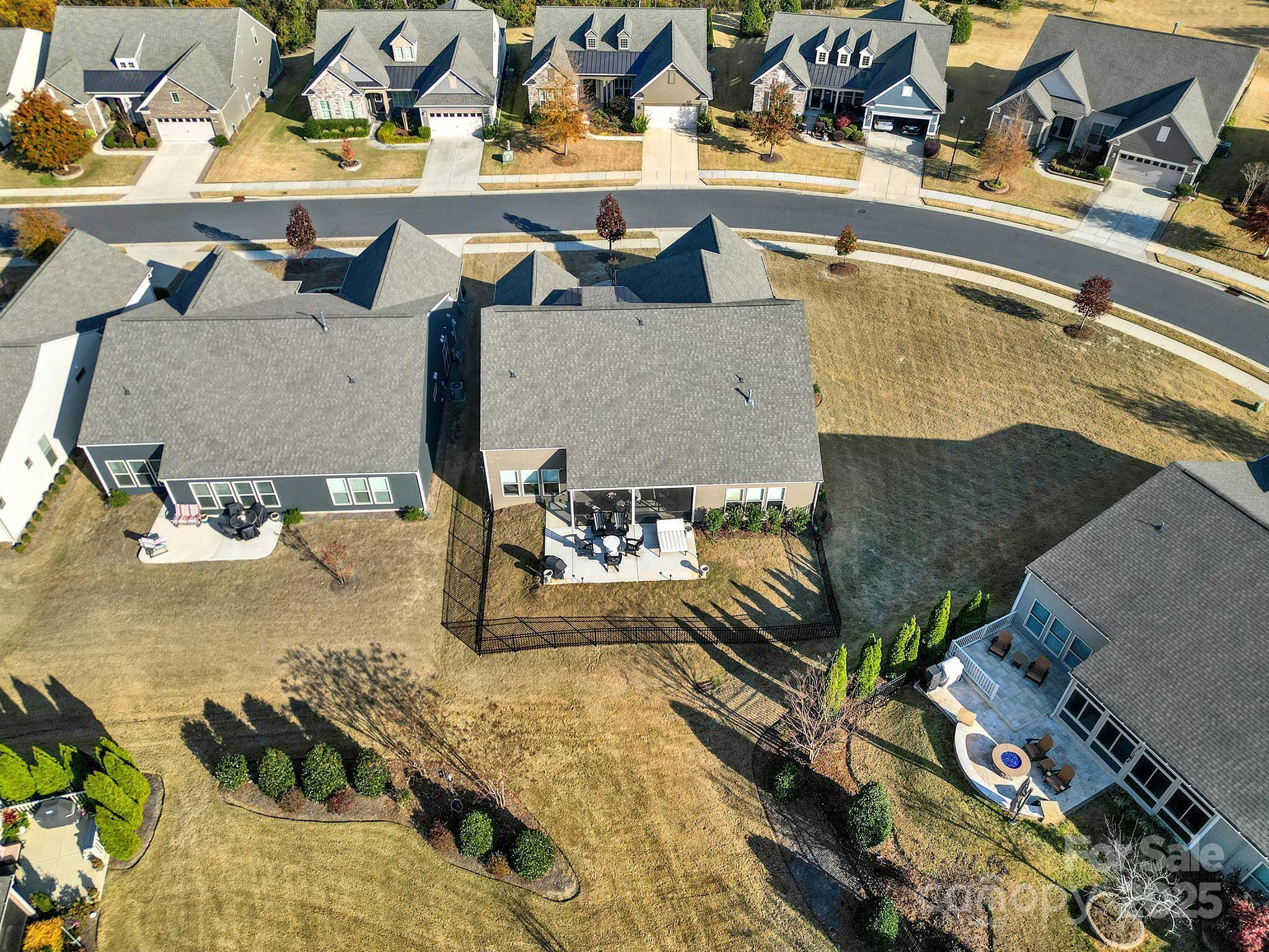 3135 Bartlett Street Fort Mill, SC 29715 - Photo 36 of 43 a view of a swimming pool with a lawn chairs and potted plants