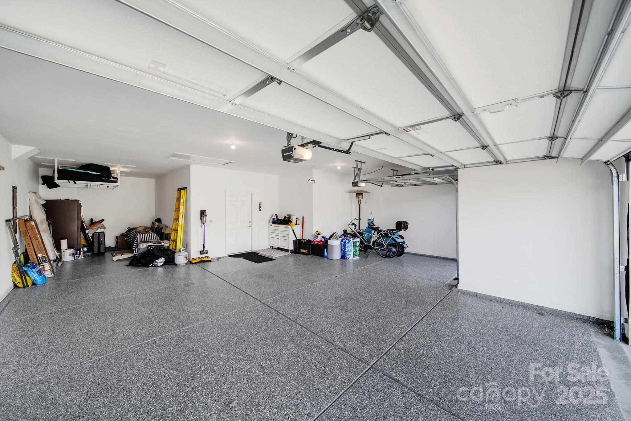 3135 Bartlett Street Fort Mill, SC 29715 - Photo 38 of 43 a view of a garage with a bike and car