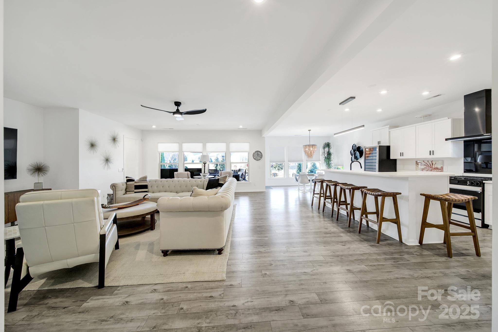 3135 Bartlett Street Fort Mill, SC 29715 - Photo 5 of 43 a living room with furniture and a dining table with wooden floor