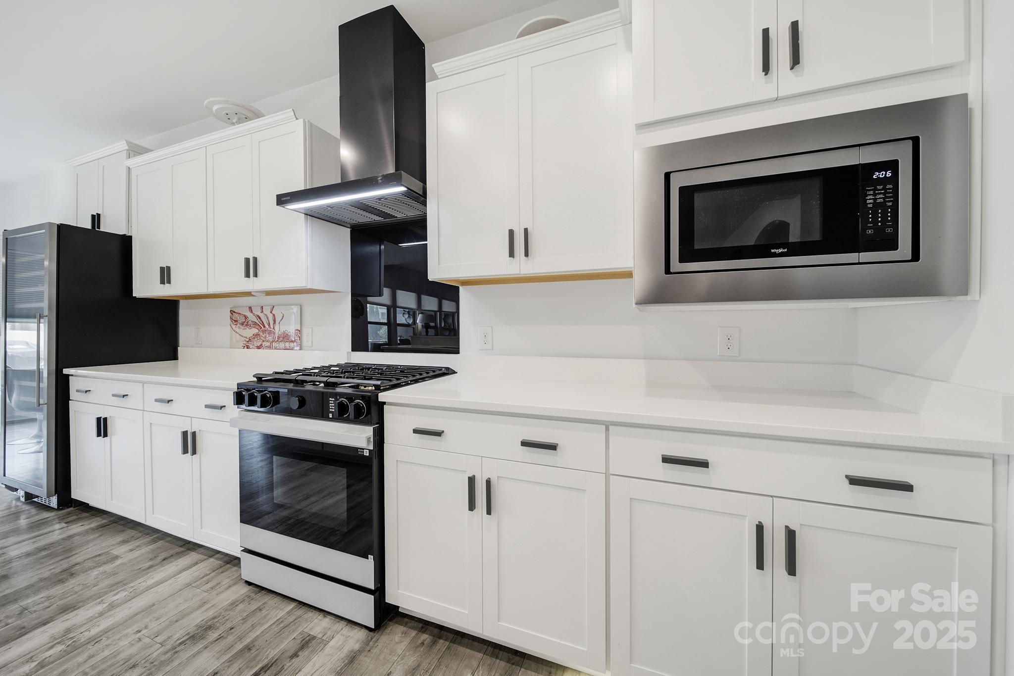 3135 Bartlett Street Fort Mill, SC 29715 - Photo 9 of 43 a kitchen with stainless steel appliances granite countertop a stove a microwave and a refrigerator