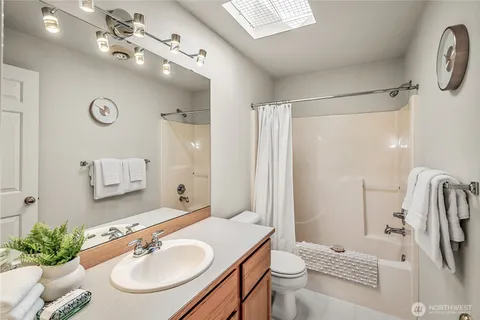 a bathroom with a sink double vanity granite tub and shower