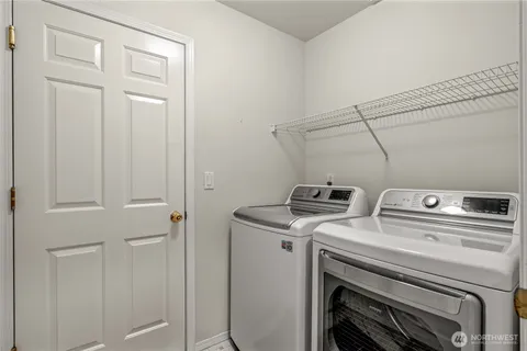 a view of storage and utility room with washer and dryer