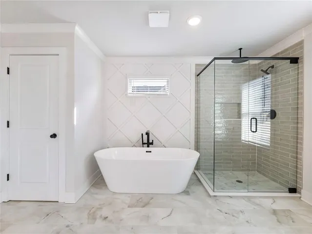 a bathroom with a shower and a sink