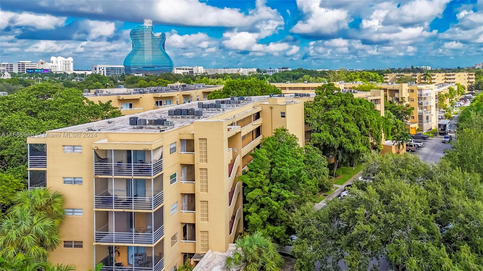an aerial view of multiple houses with a yard