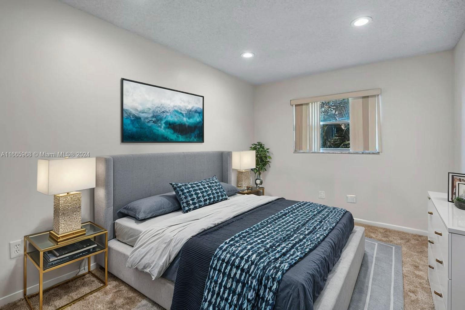 4111 Stirling Road, Unit 304 Fort Lauderdale, FL 33314 - Photo 12 of 22 a bedroom with a bed and a lamp on a dresser