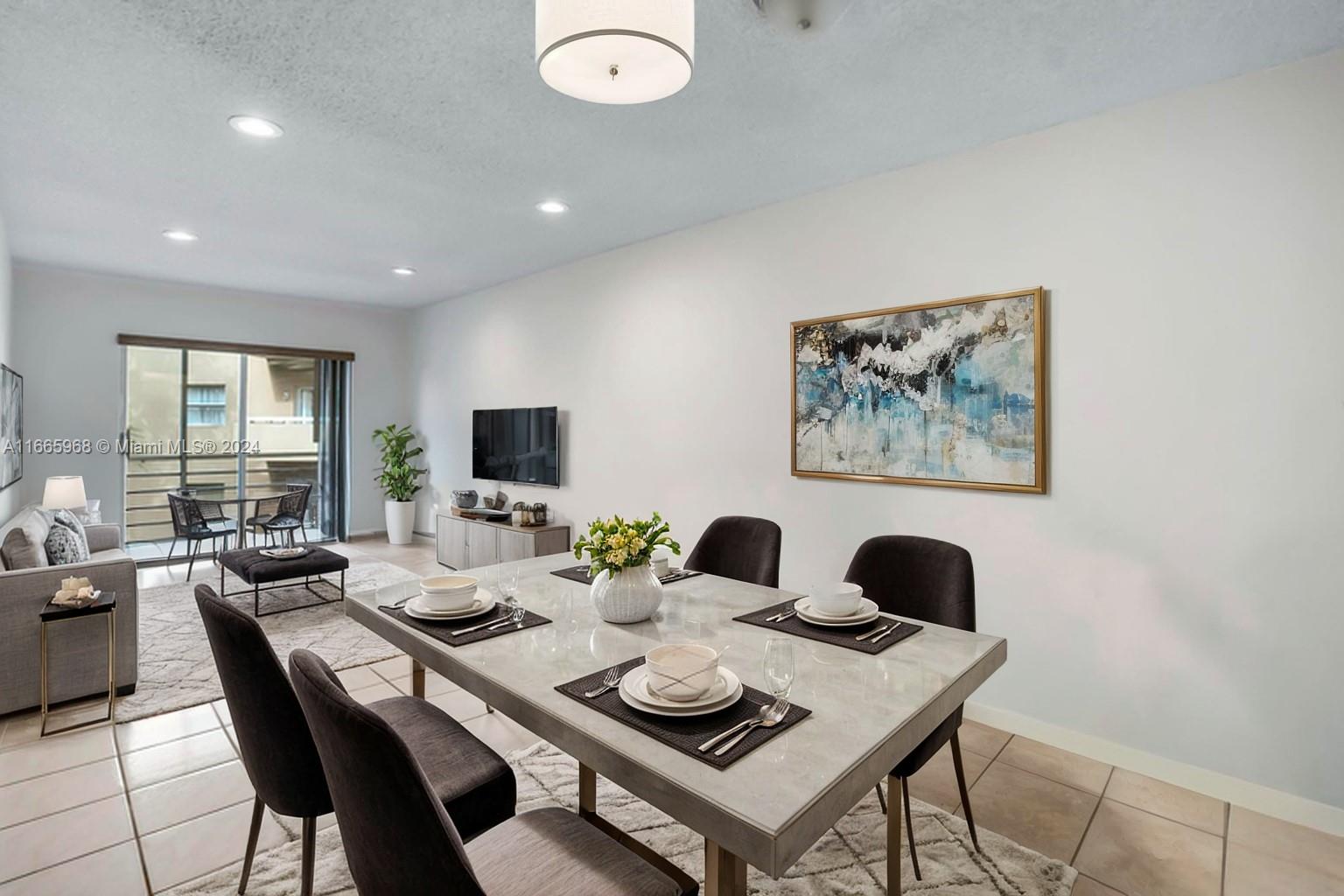 4111 Stirling Road, Unit 304 Fort Lauderdale, FL 33314 - Photo 3 of 22 a dining room with furniture a rug and a window