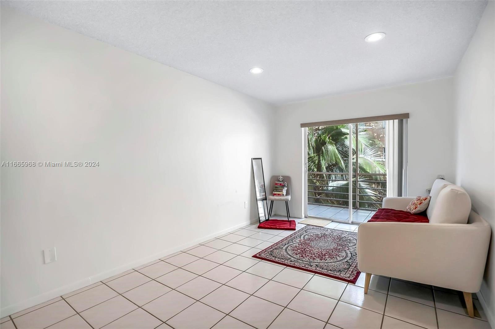 4111 Stirling Road, Unit 304 Fort Lauderdale, FL 33314 - Photo 5 of 22 a living room with furniture and floor to ceiling window
