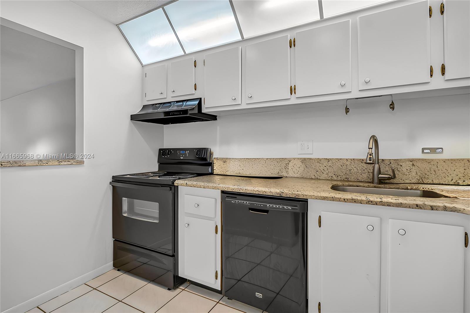 4111 Stirling Road, Unit 304 Fort Lauderdale, FL 33314 - Photo 8 of 22 a kitchen with stainless steel appliances granite countertop a sink and a white cabinets