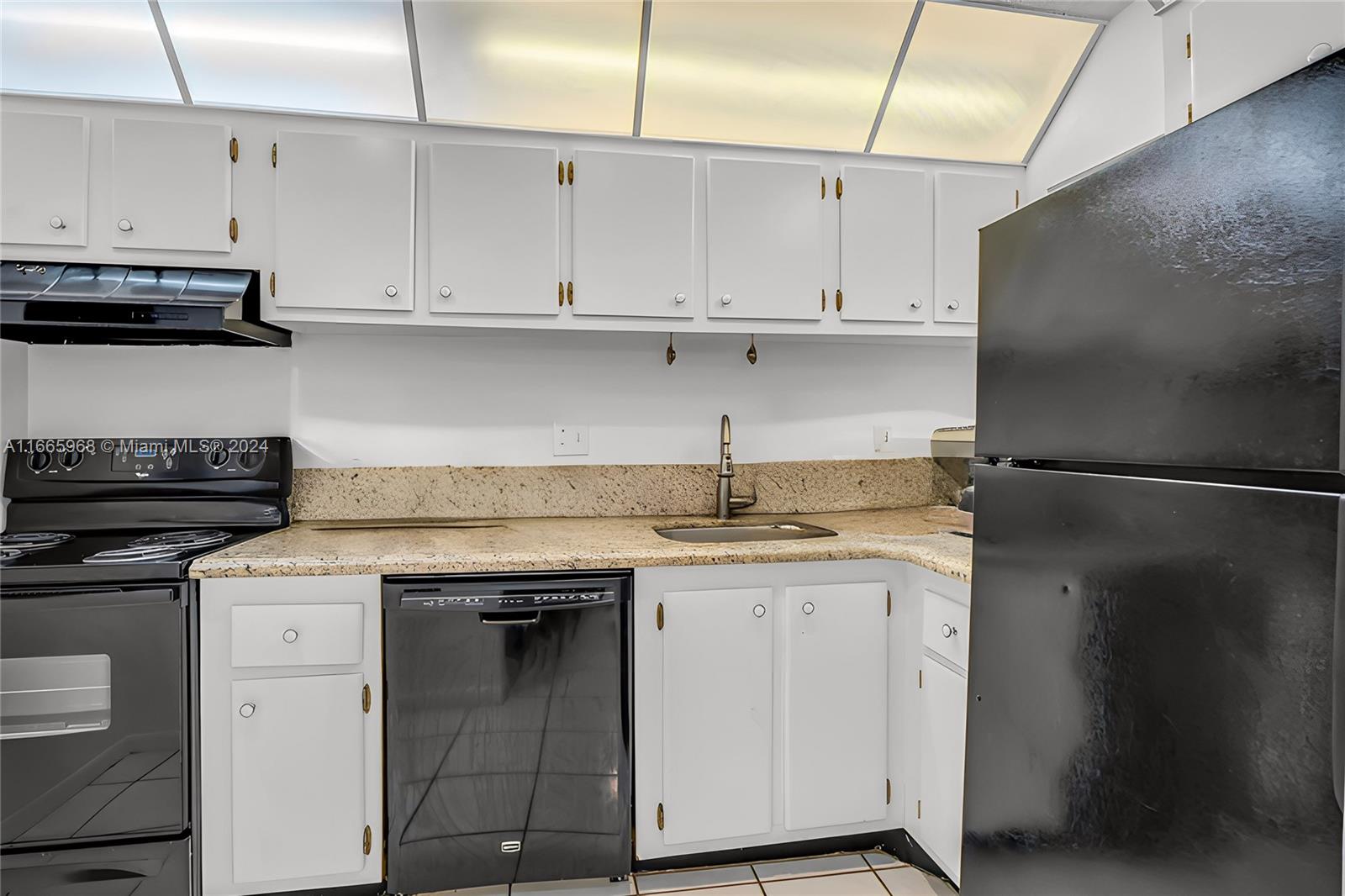 4111 Stirling Road, Unit 304 Fort Lauderdale, FL 33314 - Photo 9 of 22 a kitchen with stainless steel appliances granite countertop a sink stove and refrigerator
