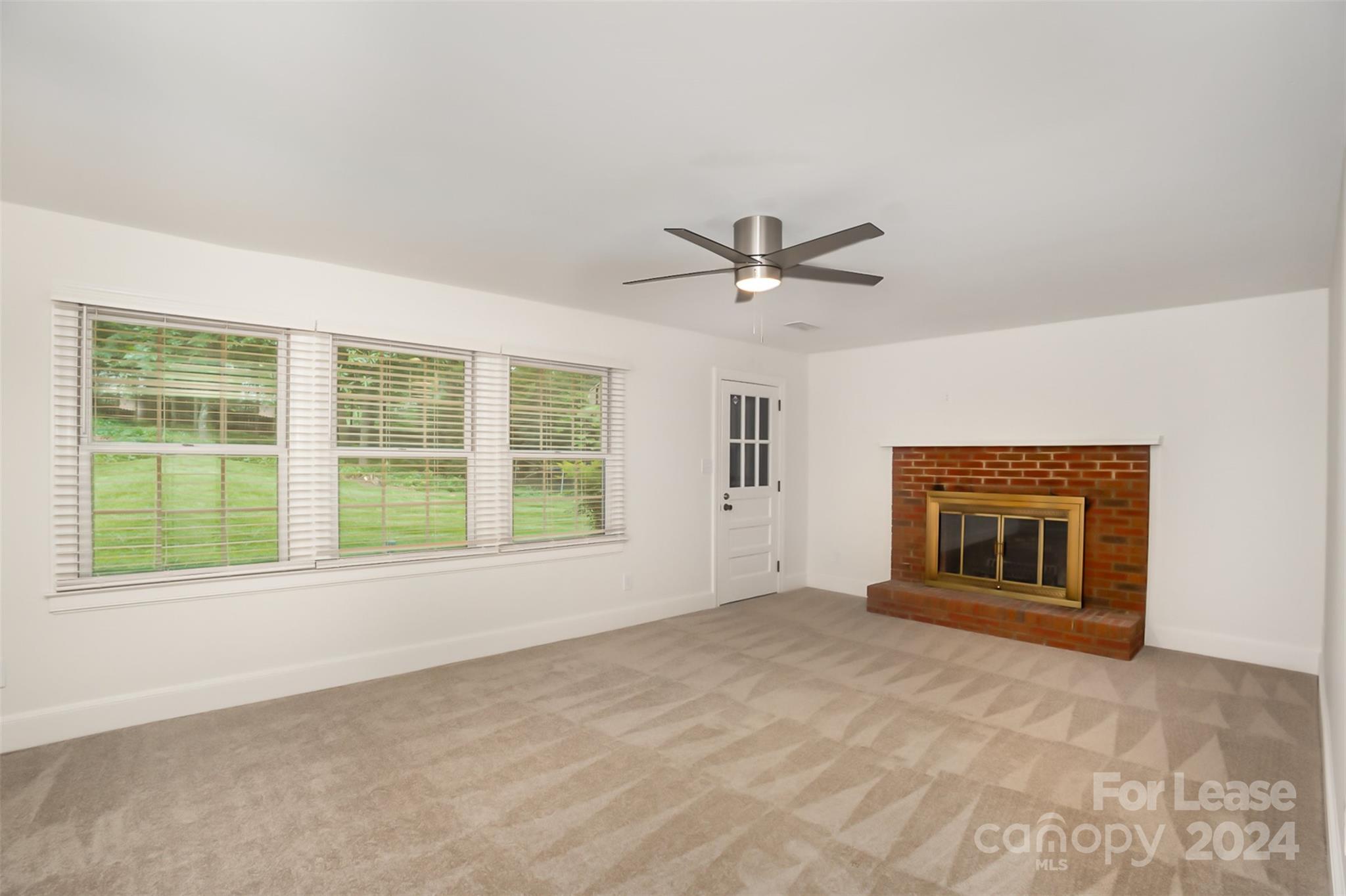 926 Shady Bluff Drive Charlotte, NC 28211 - Photo 11 of 44 a view of an empty room with a window and fireplace