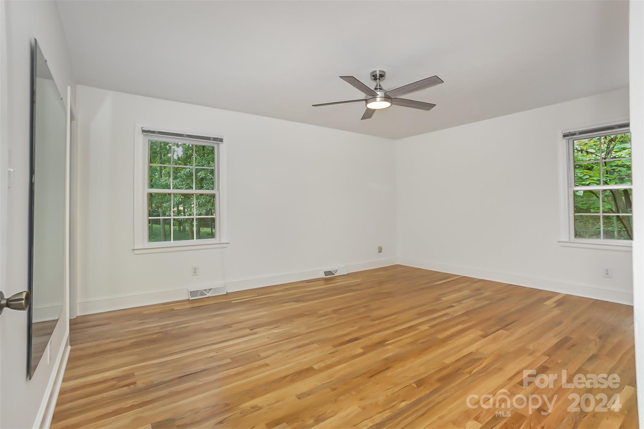 926 Shady Bluff Drive Charlotte, NC 28211 - Photo 19 of 44 a view of empty room with wooden floor and fan