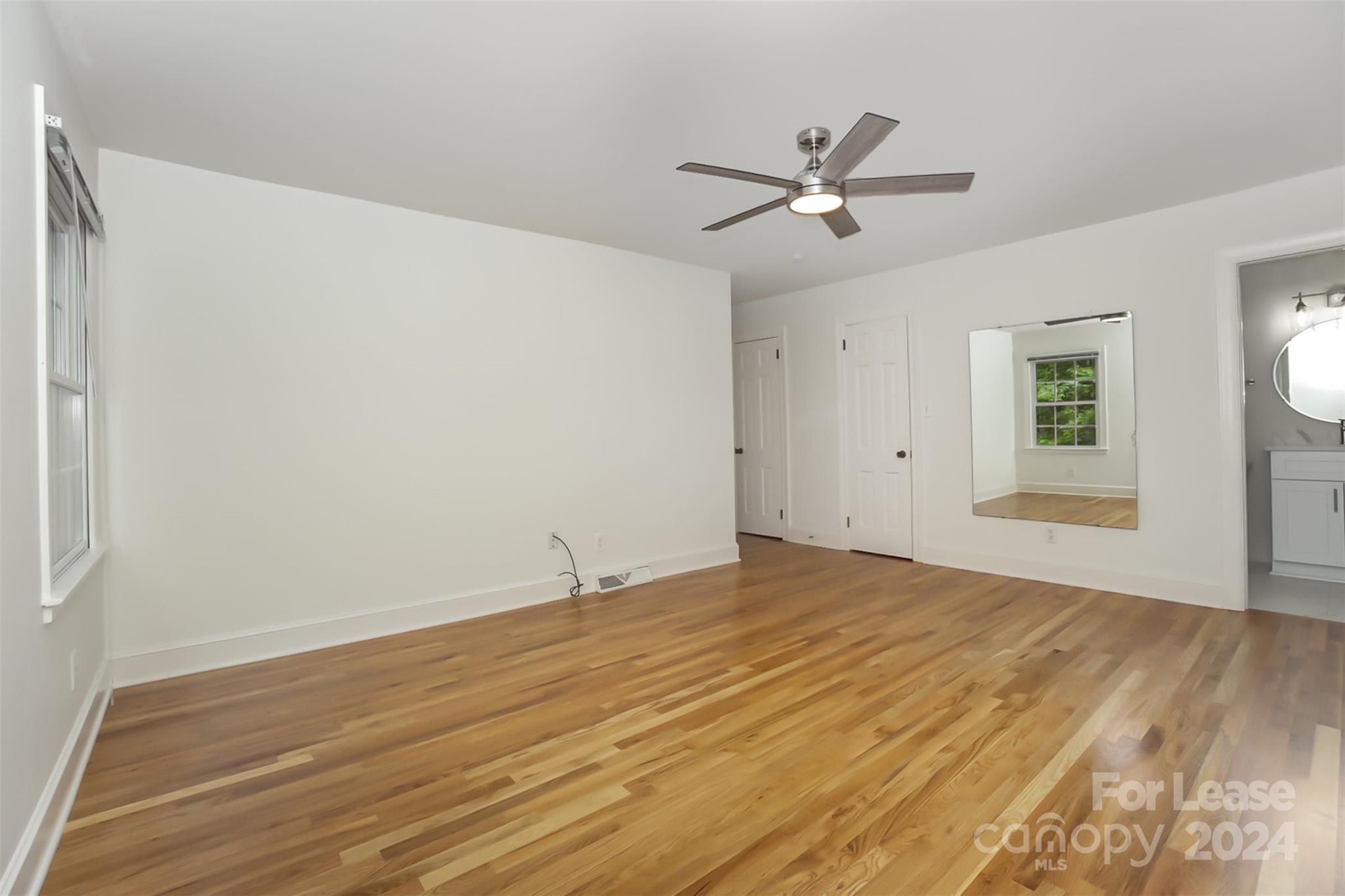 926 Shady Bluff Drive Charlotte, NC 28211 - Photo 20 of 44 a view of empty room with wooden floor and fan