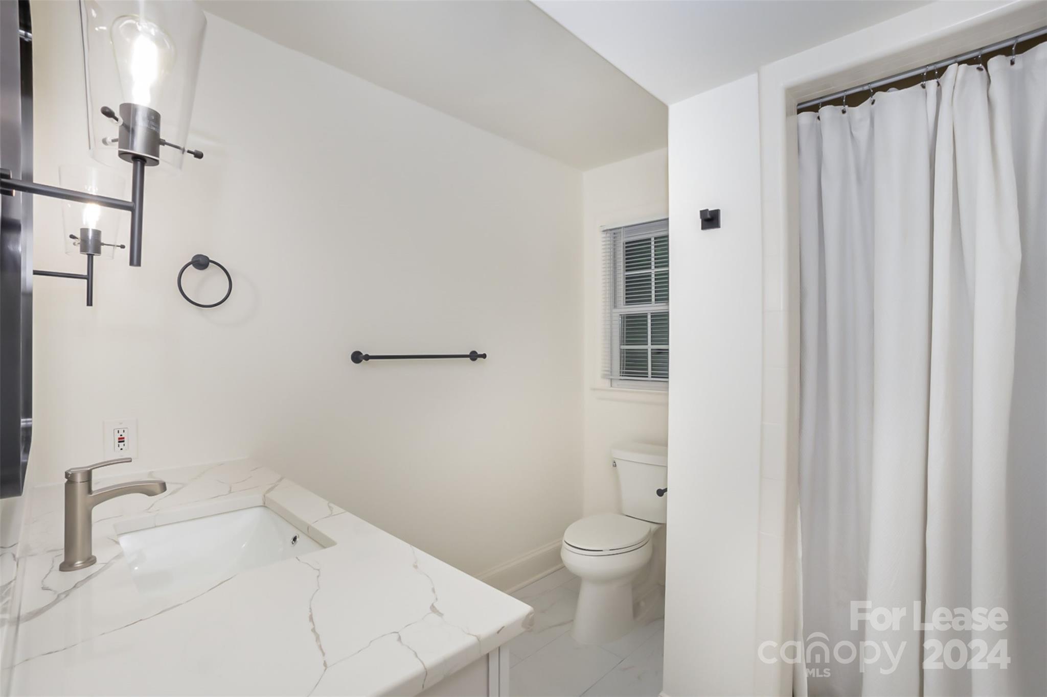 926 Shady Bluff Drive Charlotte, NC 28211 - Photo 36 of 44 a bathroom with a toilet sink and shower