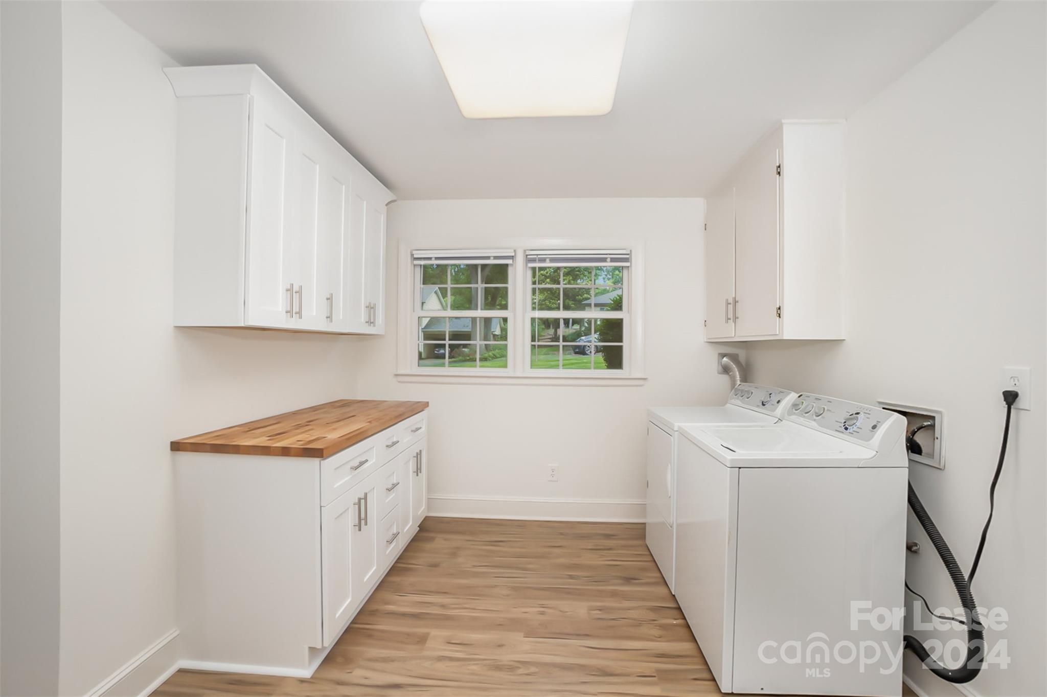 926 Shady Bluff Drive Charlotte, NC 28211 - Photo 39 of 44 a room with a sink a window and cabinets